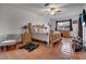 Spacious bedroom with a wood bed frame, neutral bedding, and a ceiling fan, offering a comfortable and inviting retreat at 10327 Meadow Crossing Dr, Tampa, FL 33647