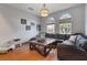 Comfortable living room featuring a stylish black leather sectional and neutral decor, perfect for relaxing and entertaining guests at 10327 Meadow Crossing Dr, Tampa, FL 33647