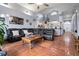 Spacious living room with vaulted ceilings, comfortable seating, and terracotta tile flooring at 10327 Meadow Crossing Dr, Tampa, FL 33647