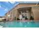 Enclosed pool area featuring a covered lanai, ceiling fans, and access to the home's interior at 10327 Meadow Crossing Dr, Tampa, FL 33647