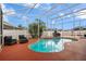 Inviting in-ground pool with a screened enclosure, surrounded by lounge seating and well-maintained patio at 10327 Meadow Crossing Dr, Tampa, FL 33647