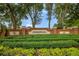 Community entrance sign with lush landscaping and mature trees, greeting residents and visitors at 10327 Meadow Crossing Dr, Tampa, FL 33647