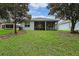 Lush backyard with a screened porch, offering a serene outdoor space for relaxation and entertaining at 11220 Paradise Pointe Way, New Port Richey, FL 34654