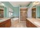 Bathroom featuring double sinks, soaking tub, and glass-enclosed shower at 11220 Paradise Pointe Way, New Port Richey, FL 34654