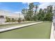 Inviting bocce ball court with seating and lush landscaping, offering a recreational outdoor space at 11220 Paradise Pointe Way, New Port Richey, FL 34654
