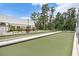 Bocce ball court with benches and shade umbrellas, next to a community building at 11220 Paradise Pointe Way, New Port Richey, FL 34654
