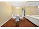 Dining area featuring modern lighting and seating, and hardwood floors, adjacent to living area at 11220 Paradise Pointe Way, New Port Richey, FL 34654