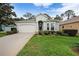 Charming one-story home featuring a manicured lawn, classic curb appeal, and an attached two-car garage at 11220 Paradise Pointe Way, New Port Richey, FL 34654