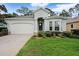 Inviting single-story home with attached garage, fresh landscaping, and a beautifully maintained lawn at 11220 Paradise Pointe Way, New Port Richey, FL 34654