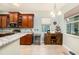 Kitchen features custom wood cabinetry, stainless steel appliances, and granite countertops at 11220 Paradise Pointe Way, New Port Richey, FL 34654