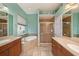 A spacious main bathroom featuring double vanities, a soaking tub, and a separate glass shower at 11220 Paradise Pointe Way, New Port Richey, FL 34654