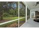 Screened porch overlooking a landscaped yard with mature trees at 11220 Paradise Pointe Way, New Port Richey, FL 34654
