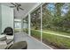 Screened porch overlooking a landscaped yard with mature trees at 11220 Paradise Pointe Way, New Port Richey, FL 34654