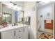 Stylish bathroom featuring a marble vanity with a framed mirror and access to a separate toilet area at 12529 Knollbrook Ln, Hudson, FL 34669