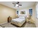 Comfortable bedroom with bright lighting and a ceiling fan at 12529 Knollbrook Ln, Hudson, FL 34669