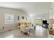 Open living room with vaulted ceilings, tile floors, and access to the outdoors at 12529 Knollbrook Ln, Hudson, FL 34669
