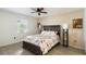 Inviting main bedroom featuring wood-look floors, a ceiling fan, and a picturesque window view at 12529 Knollbrook Ln, Hudson, FL 34669