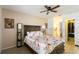 Relaxing main bedroom with wood-look floors, ceiling fan, en suite bathroom, and a walk-in closet for ample storage at 12529 Knollbrook Ln, Hudson, FL 34669