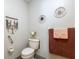 Cozy powder room featuring charming wall decor and neatly arranged towels at 12529 Knollbrook Ln, Hudson, FL 34669