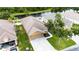 Aerial view of a single-story home with a well-manicured lawn and two-car garage at 12631 Chenwood Ave, Hudson, FL 34669