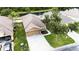 Aerial view of a home featuring a spacious driveway, a two-car garage and mature tree at 12631 Chenwood Ave, Hudson, FL 34669