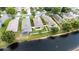 Aerial view showcases waterfront community homes with screened in pools and lush green lawns at 12631 Chenwood Ave, Hudson, FL 34669
