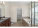 Bathroom featuring a soaking tub, walk-in shower, toilet and a sink with vanity at 12631 Chenwood Ave, Hudson, FL 34669