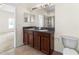 Bathroom featuring double sinks, a walk-in shower, large mirror, and tile floors at 12631 Chenwood Ave, Hudson, FL 34669