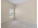 Neutral bedroom with carpet flooring, a window overlooking the outdoors, and electrical outlets at 12631 Chenwood Ave, Hudson, FL 34669