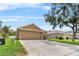 Well-maintained single-story home with a two-car garage, and a spacious driveway at 12631 Chenwood Ave, Hudson, FL 34669