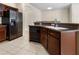 Close up of kitchen with stainless steel fridge, modern cabinets and island with bar seating at 12631 Chenwood Ave, Hudson, FL 34669