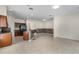 Open concept living area with a kitchen island, stainless steel fridge, and tile flooring at 12631 Chenwood Ave, Hudson, FL 34669