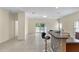 Open floor plan with tile flooring and access to a patio through sliding glass doors at 12631 Chenwood Ave, Hudson, FL 34669