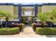 Secured building entrance with mature landscaping and tiled accents at 1301 S Howard Ave # A9, Tampa, FL 33606