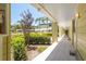 Exterior hallway view with lush landscaping and multiple unit entrances at 1301 S Howard Ave # A9, Tampa, FL 33606