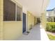 Hallway view of a unit entrance, with a window, and an outdoor rug at 1301 S Howard Ave # A9, Tampa, FL 33606