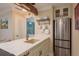 Bright, modern kitchen with stainless steel appliances and stylish hanging pot rack at 1301 S Howard Ave # A9, Tampa, FL 33606