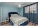 Cozy main bedroom with blue walls, a ceiling fan, and plenty of natural light at 1301 S Howard Ave # A9, Tampa, FL 33606