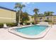 Community pool featuring palm trees and lounge chairs at 1301 S Howard Ave # A9, Tampa, FL 33606