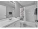 Bathroom with white tile, shower-tub combo and neutral tones at 1312 Kelridge Pl, Brandon, FL 33511
