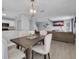 Open dining area next to the kitchen and living room, with upholstered chairs and hanging lights at 1312 Kelridge Pl, Brandon, FL 33511