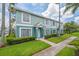 Charming townhouse showcasing lush green lawn and manicured shrubs, painted in refreshing two-tone color at 1312 Kelridge Pl, Brandon, FL 33511