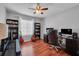 Comfortable home office with hardwood floors, ceiling fan, guitars and built in bookshelves at 1312 Kelridge Pl, Brandon, FL 33511