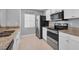 Galley kitchen featuring stainless steel appliances and granite countertops at 1312 Kelridge Pl, Brandon, FL 33511