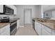 Kitchen featuring stainless appliances, white cabinets, and granite countertops at 1312 Kelridge Pl, Brandon, FL 33511