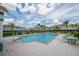 Community pool with lounge chairs and tables and well maintained landscaping and building exterior at 1312 Kelridge Pl, Brandon, FL 33511