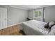 Bright bedroom with wood-look floors includes a window for natural light and neutral walls at 13285 Arbor Pointe Cir # 202, Tampa, FL 33617
