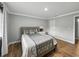 Comfortable bedroom with hardwood flooring features a luxurious bed and simple decor at 13285 Arbor Pointe Cir # 202, Tampa, FL 33617