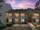 Charming condo building with two-story design and cozy patios overlooking the well-maintained landscaping at dusk at 13285 Arbor Pointe Cir # 202, Tampa, FL 33617