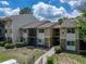 Well-maintained condo complex with two-story units, screened patios, and lush greenery creating a welcoming ambiance at 13285 Arbor Pointe Cir # 202, Tampa, FL 33617